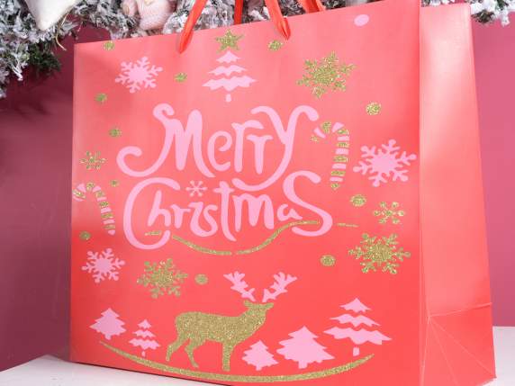 Colored paper bag with Christmas decorations and glitter