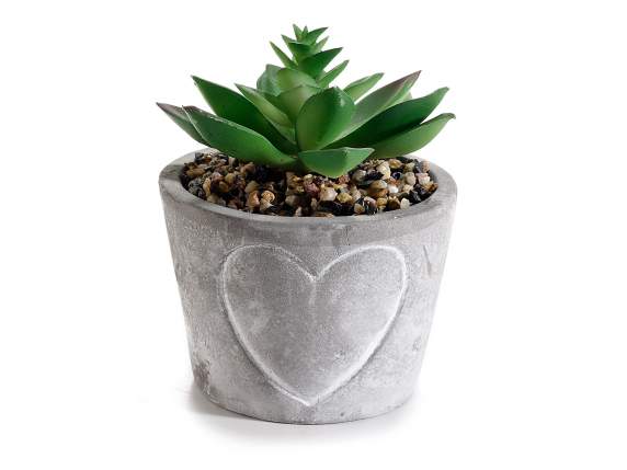 Concrete vase with heart decoration and fat plant