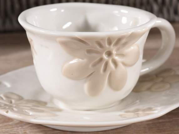 Porcelain cup and saucer with embossed flower decorations
