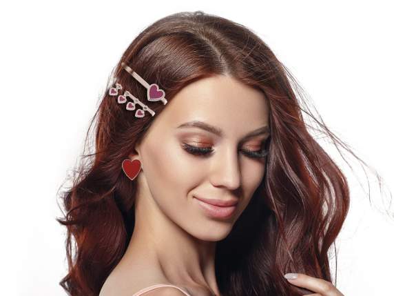 Set of 2 enameled heart hair clips, rose gold color on displ