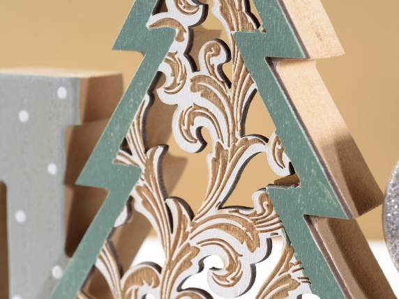 Xmas written in wood with carved tree to rest